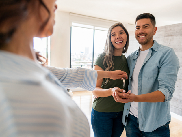 Man and woman getting keys to new home.